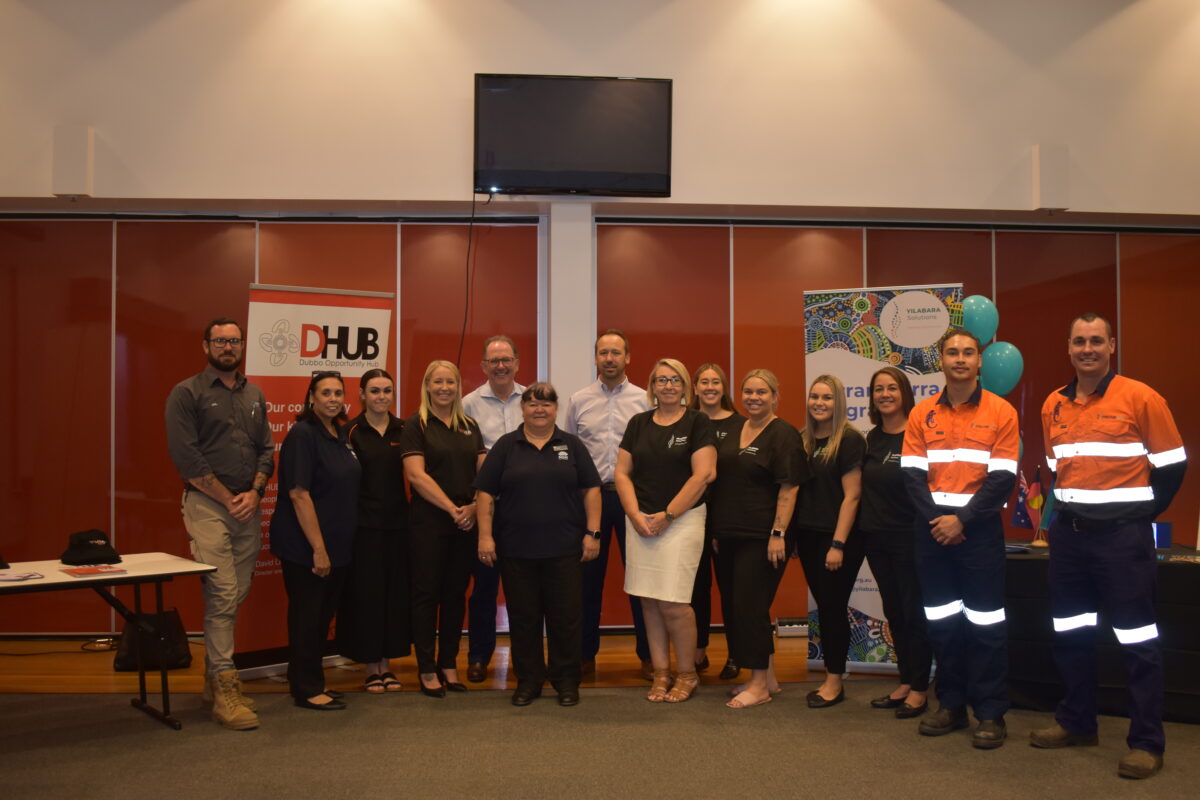 Group of people in workwear posing together indoors